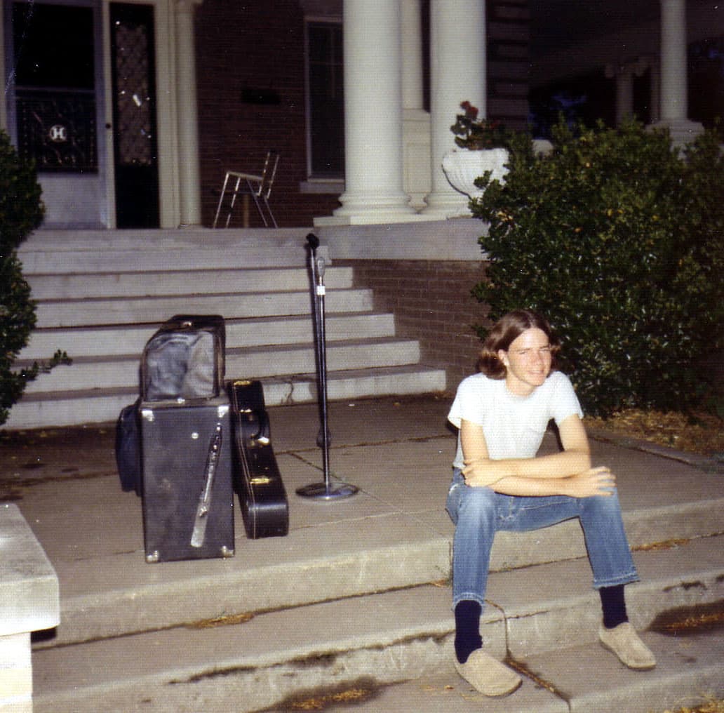 Michael outside his family's home in Enid. Michael sitting on steps at home in Enid